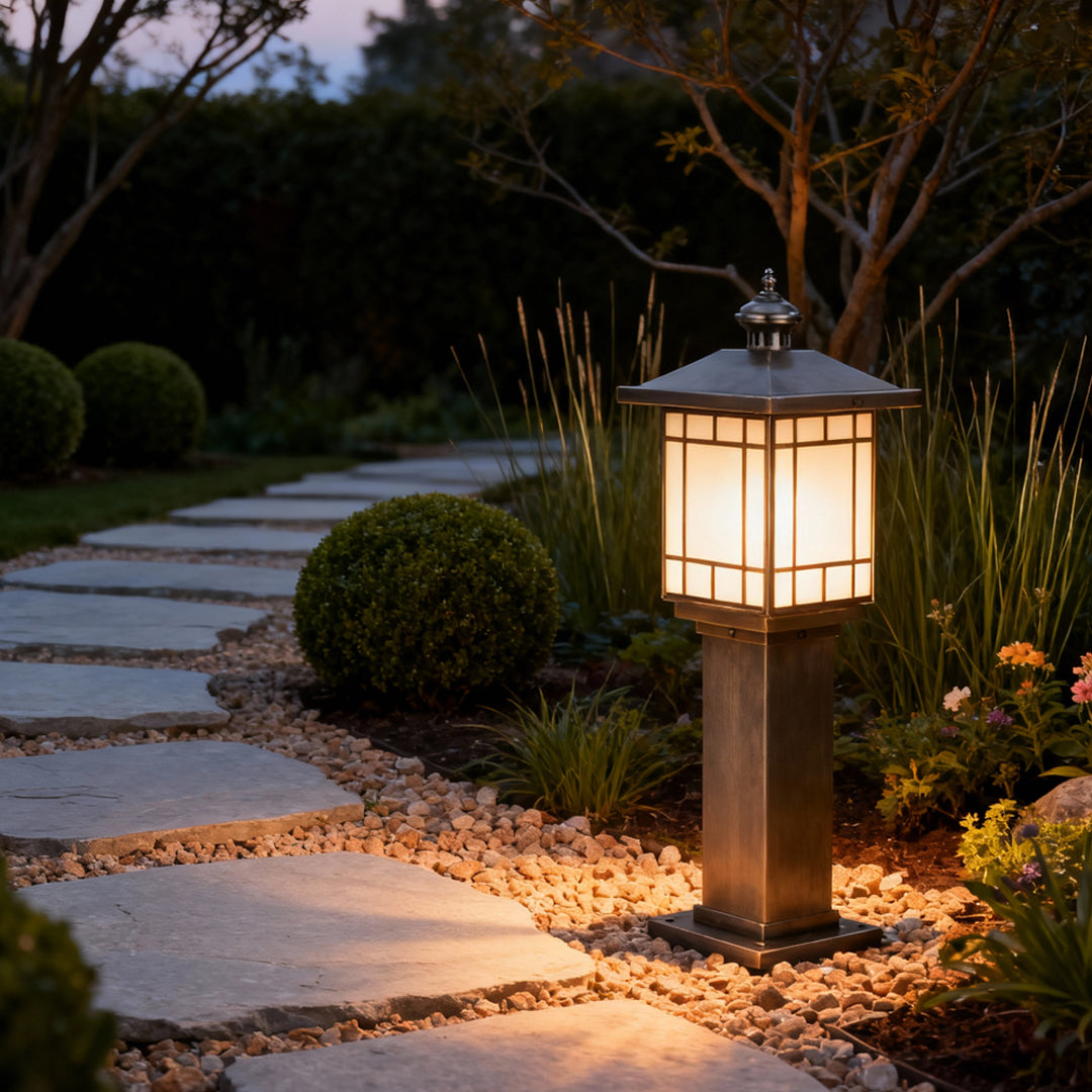 LED bollard landscape lighting installed along a stone garden path, casting a warm glow for safe nighttime navigation.