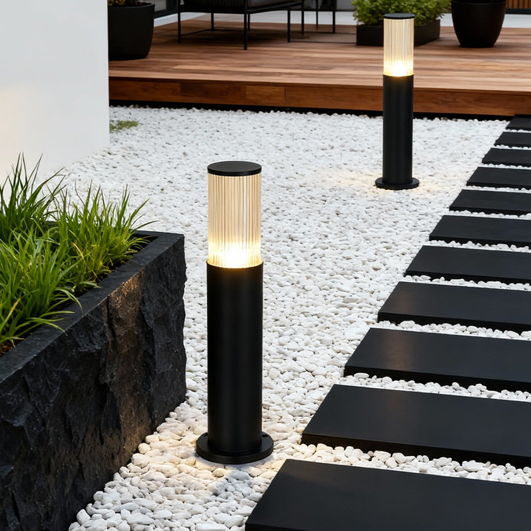 Bollard path light with ribbed glass lantern combines durable construction and warm lighting for stylish, reliable landscape paths.