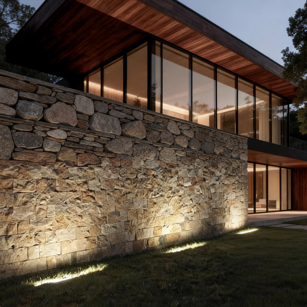 LED building facade lighting illuminating a modern house exterior with warm glow and stone wall texture.