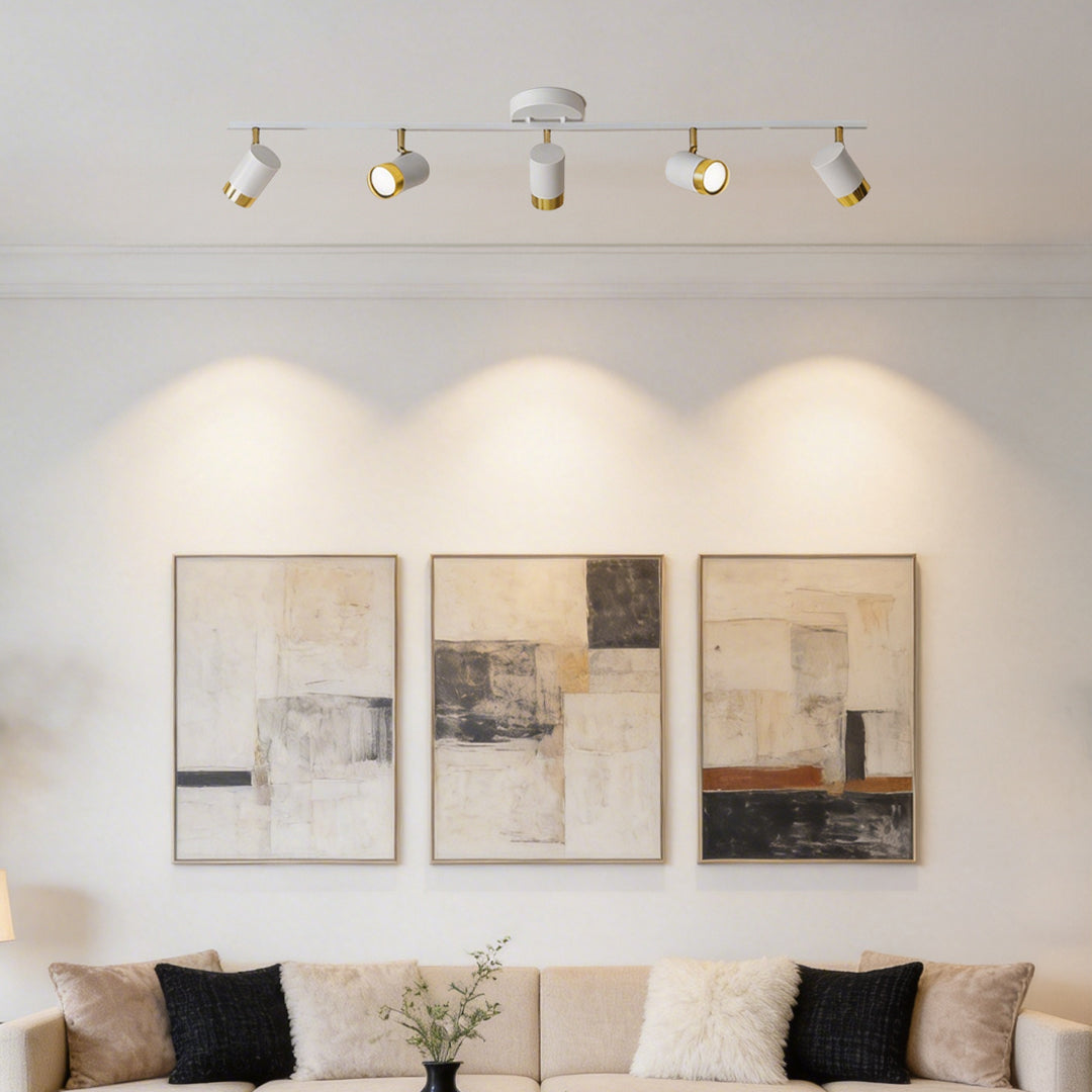 LED ceiling track spotlights with a sleek white and gold design, installed in a modern living room.