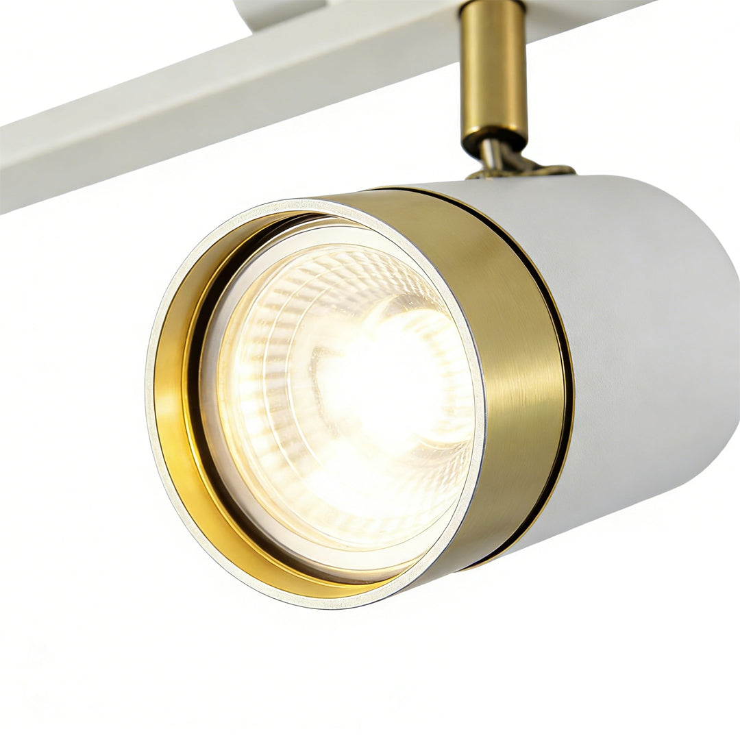 LED ceiling track spotlights with a white and gold finish, enhancing a contemporary living room.