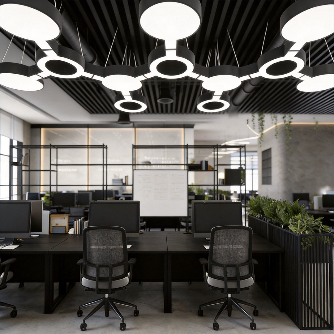 Led chandelier modern design above shared office desks, showcasing linked round LED elements for a clean and contemporary ceiling look.