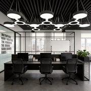 Led chandelier modern installed in an open-plan office, featuring circular LED modules that create uniform lighting for collaborative workspaces.