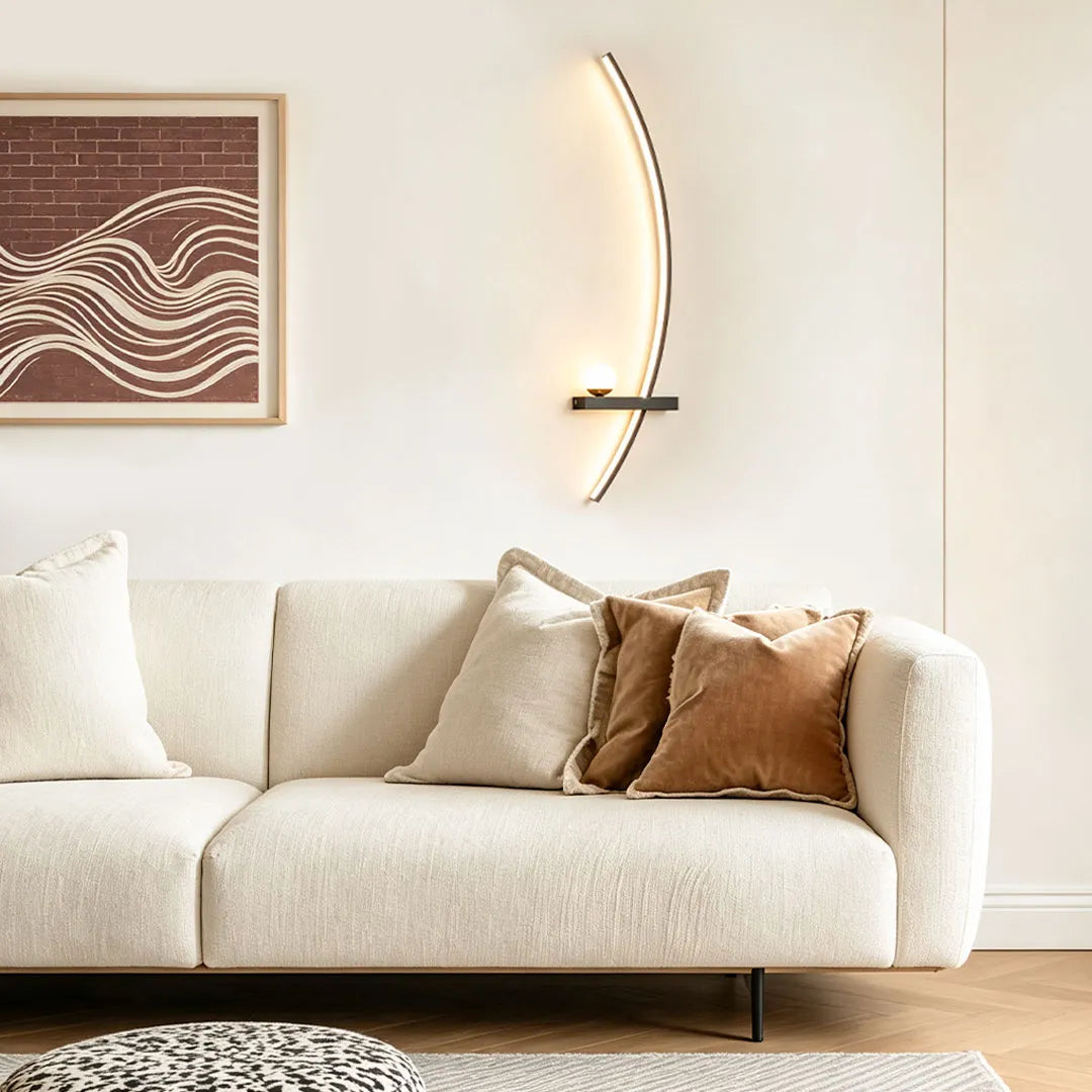 LED curved wall light installed above a sofa in a modern living room with a warm minimalist design.