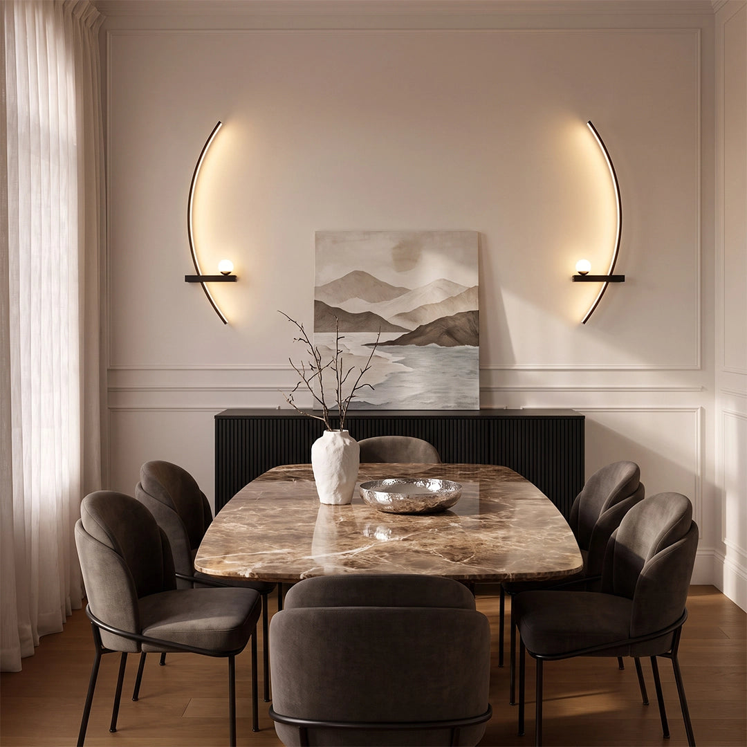 LED curved wall lights mounted symmetrically above a dining console, adding sculptural warm lighting to a modern dining room.