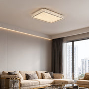 Round LED flush mount ceiling light fixture creating warm ambiance in a bedroom.