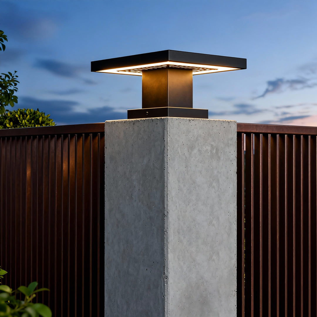 Evening exterior scene with a led gate pillar light mounted on a textured stone post giving ambient yard lighting.