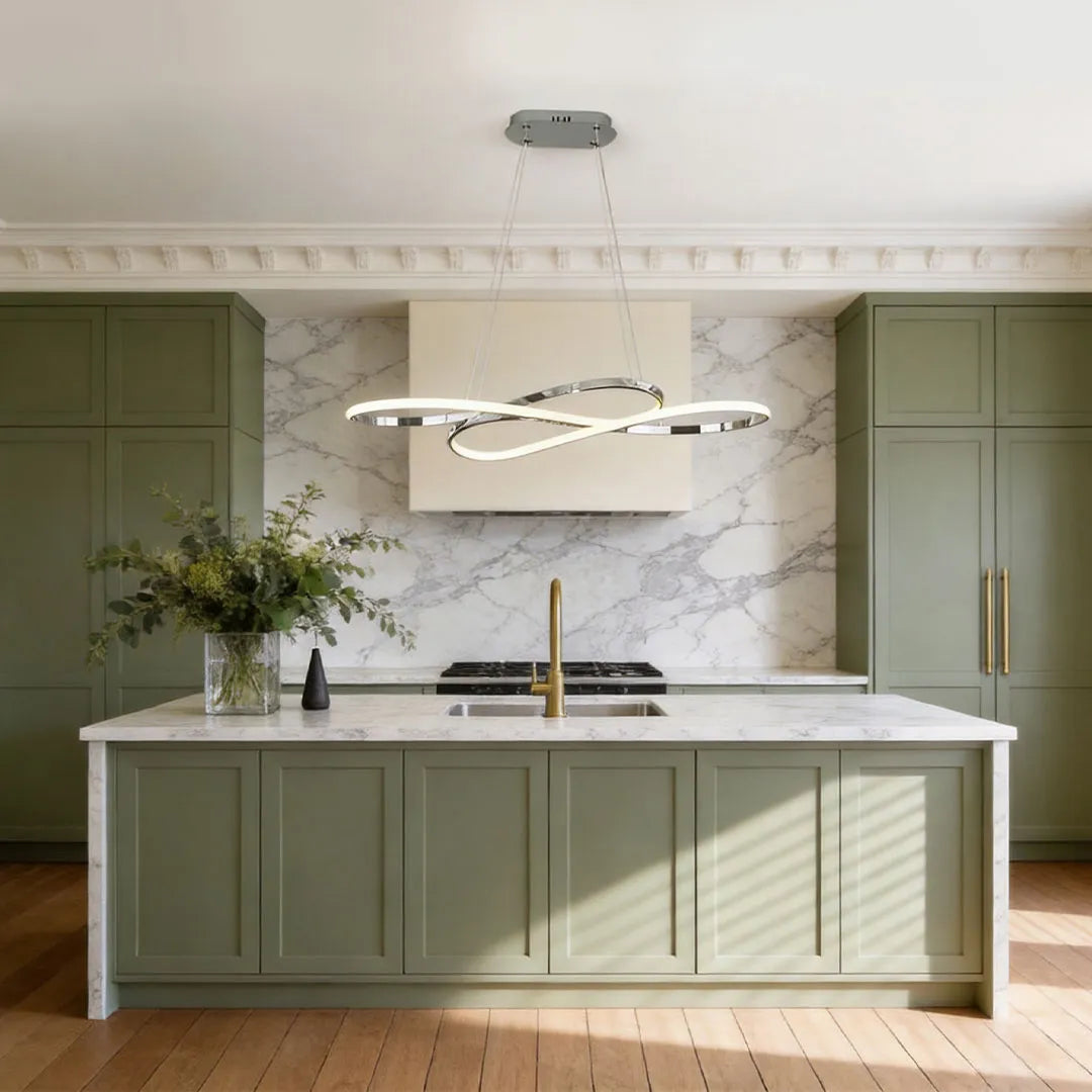 LED infinity chandelier suspended over a light green kitchen island with a marble backsplash and classic trim.