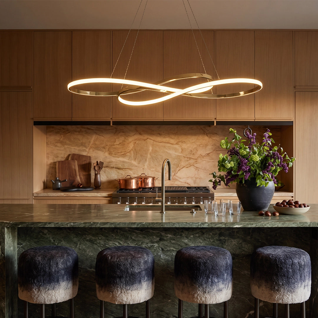LED infinity chandelier suspended above a kitchen island, featuring a flowing loop design with warm integrated lighting.