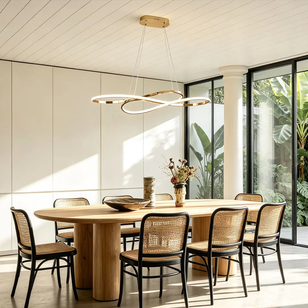 LED infinity chandelier installed above a round dining table in a bright modern dining space.