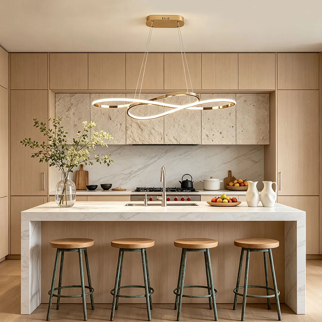 LED infinity chandelier hanging above a white kitchen island with natural wood cabinetry and bar stools.