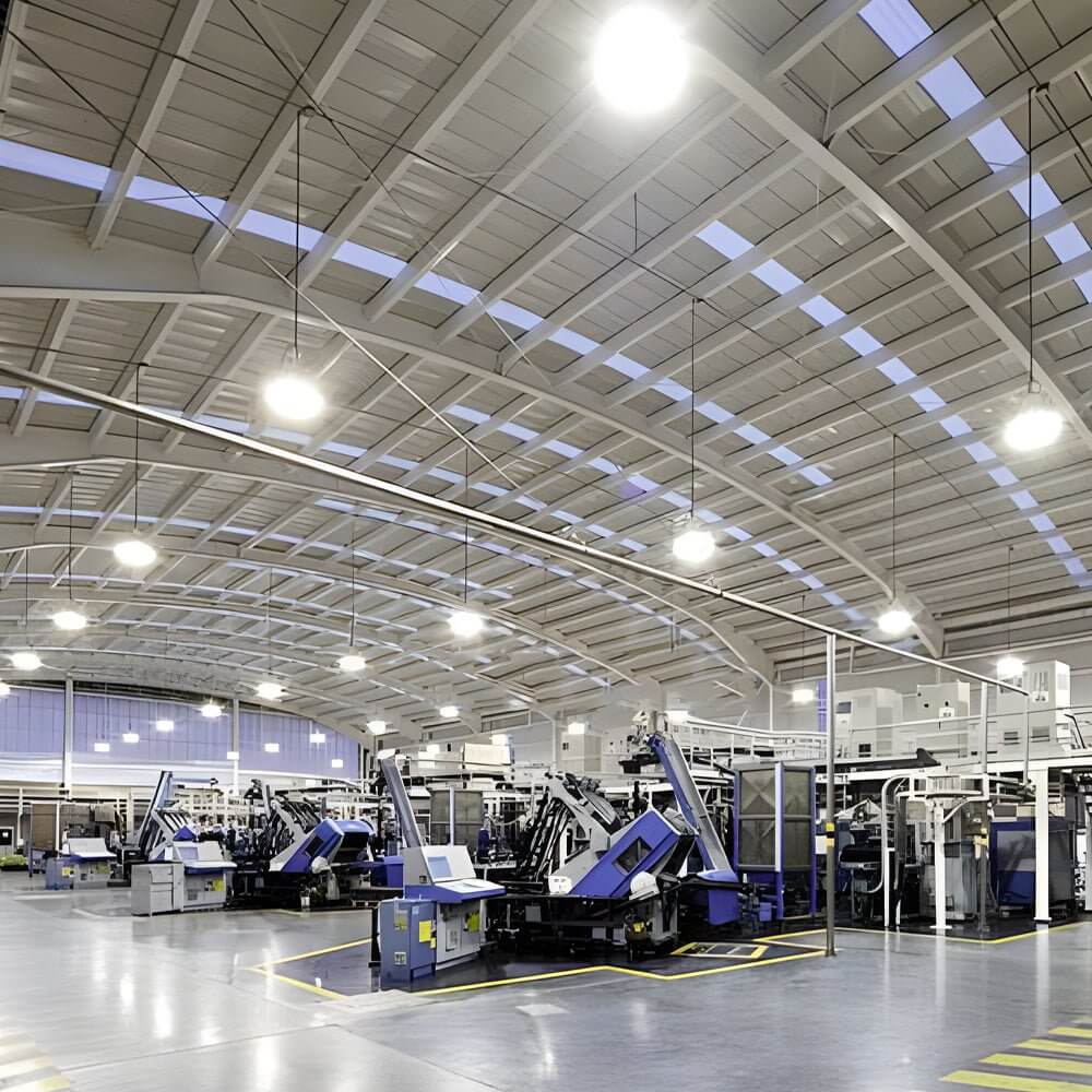 LED lamp for warehouse illuminating a busy manufacturing area with machinery.