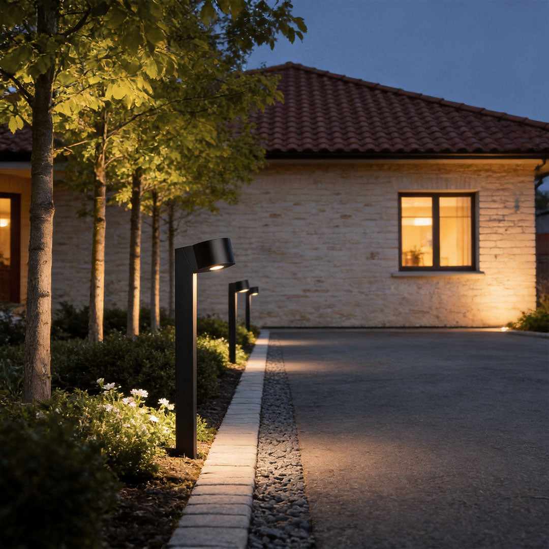 LED landscape path lighting illuminating a residential driveway and front path at night.