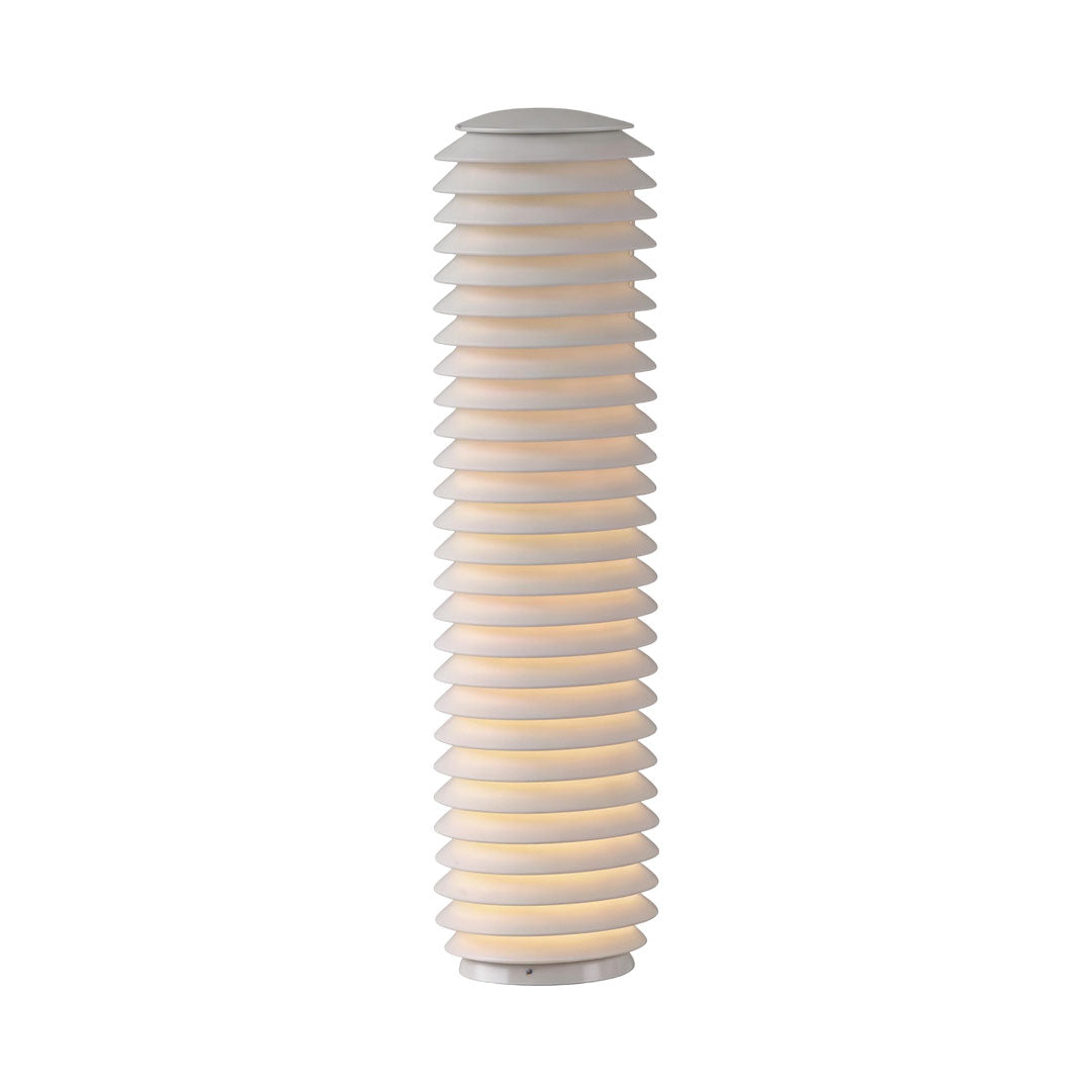 LED light bollard with a contemporary design, illuminating a landscaped garden.