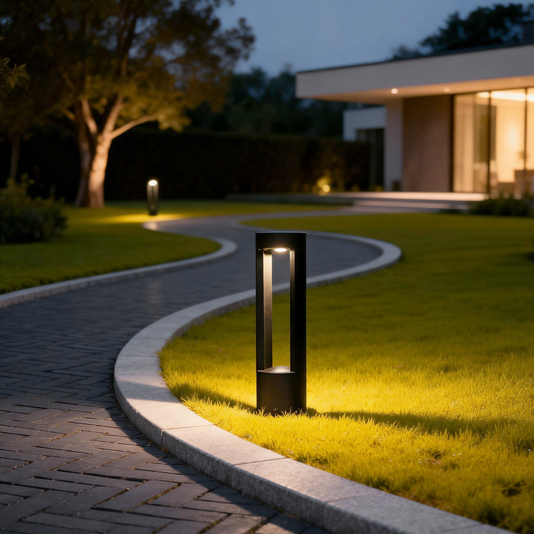 LED light bollard illuminating a modern garden pathway with warm directional glow.