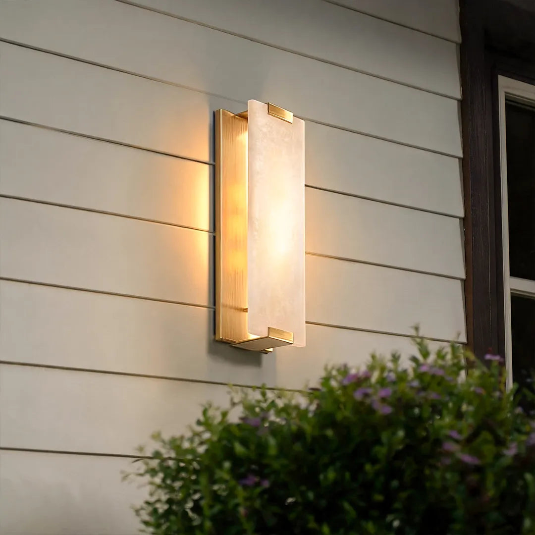 LED light wall lamp casting warm accent lighting across exterior siding and landscaping.