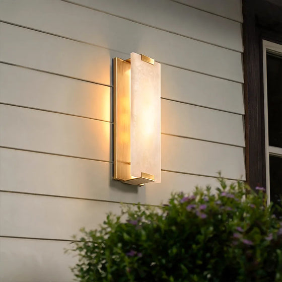 LED light wall lamp casting warm accent lighting across exterior siding and landscaping.