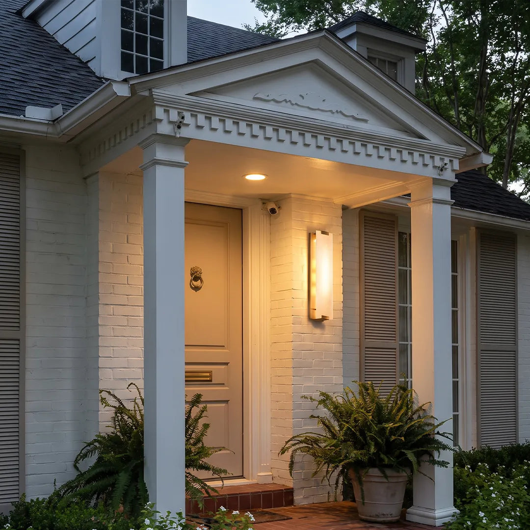 LED light wall lamp installed beside a covered front entrance for warm exterior lighting.