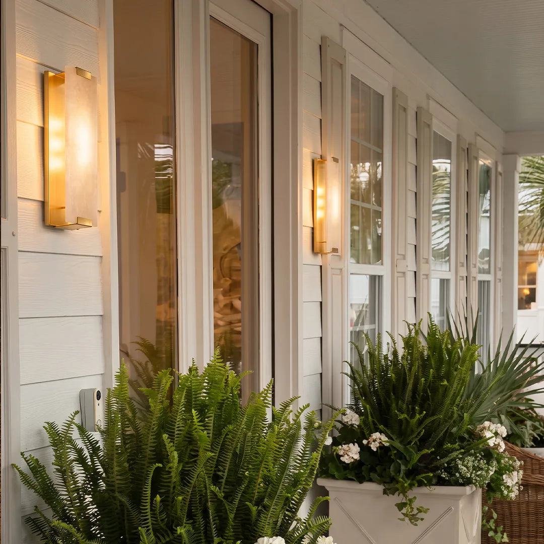 LED light wall lamp mounted beside glass doors to provide welcoming porch illumination.