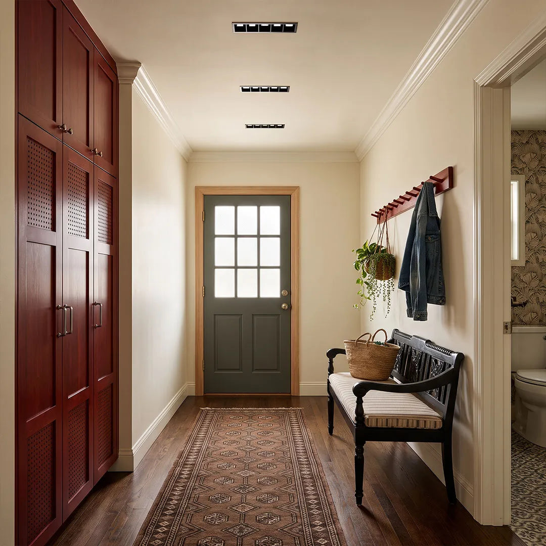 LED linear downlight fixtures arranged along an entry hallway ceiling for clean and focused illumination.