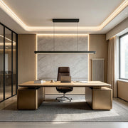 Modern LED linear suspension light installed above an executive office desk.
