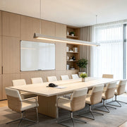 Modern LED linear suspension lighting installed above a contemporary conference table.