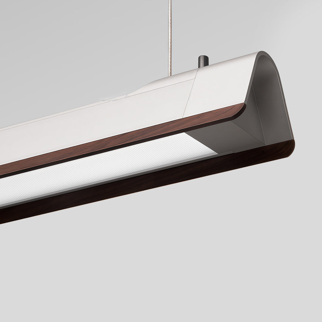 Close-up detail of LED linear suspension lighting with sleek curved housing design.
