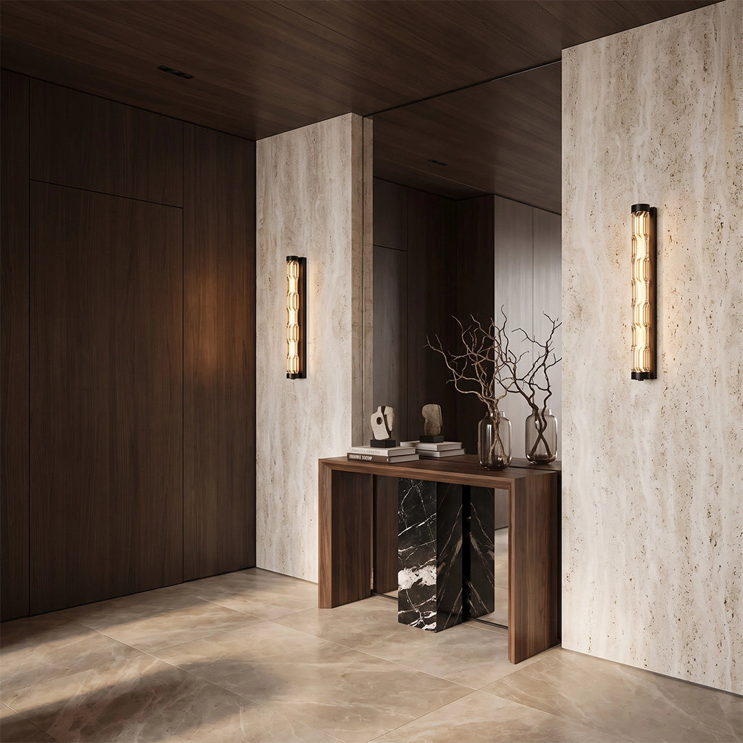 LED linear wall lights illuminating a modern hallway with dark wood and textured stone walls.