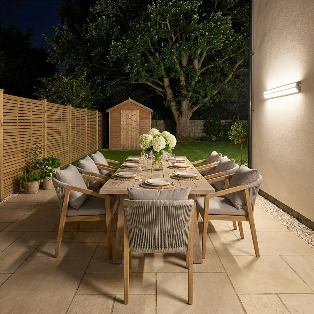 LED linear wall sconce adding ambient lighting to an outdoor dining area at night.