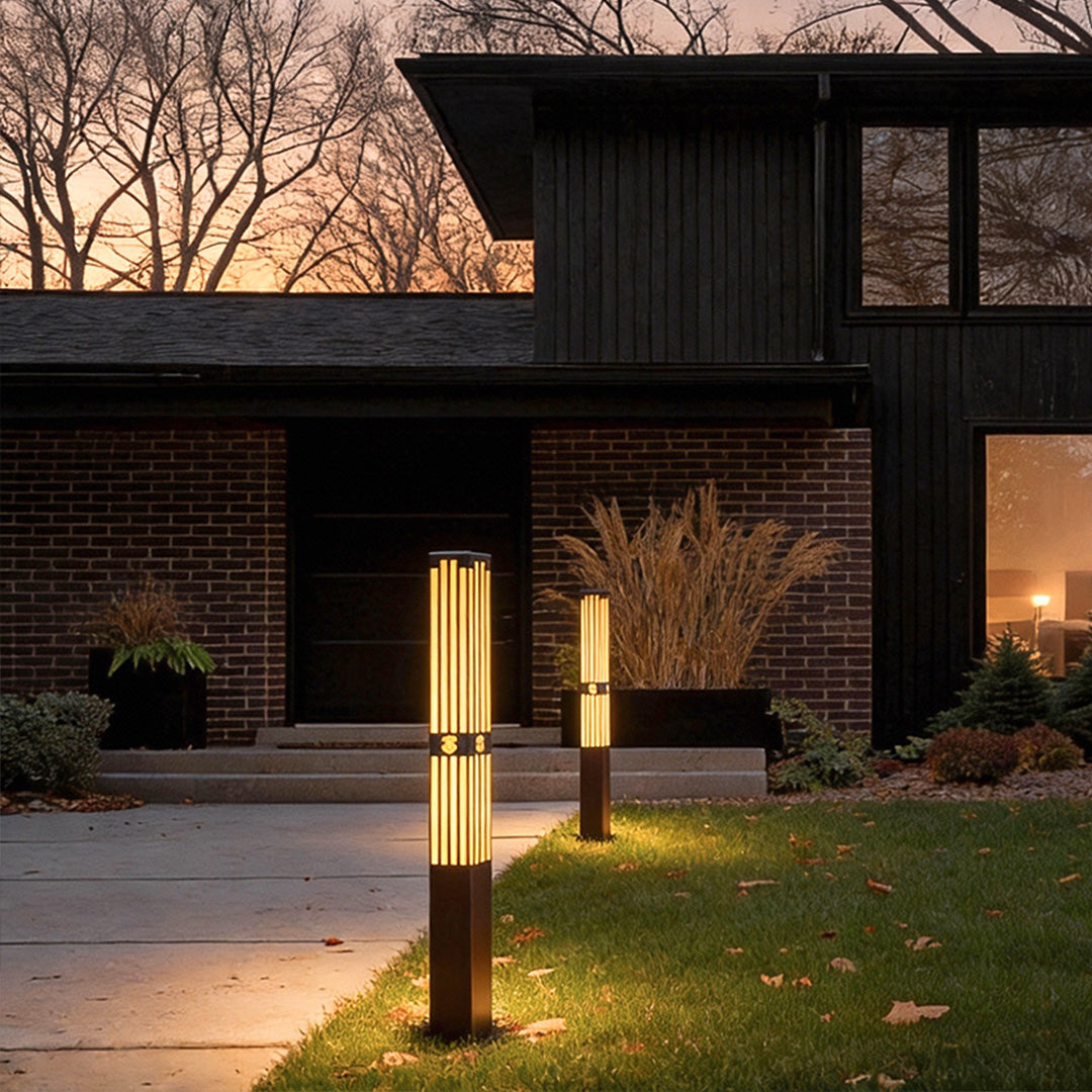 LED marble bollard light providing soft illumination beside a modern house entrance.