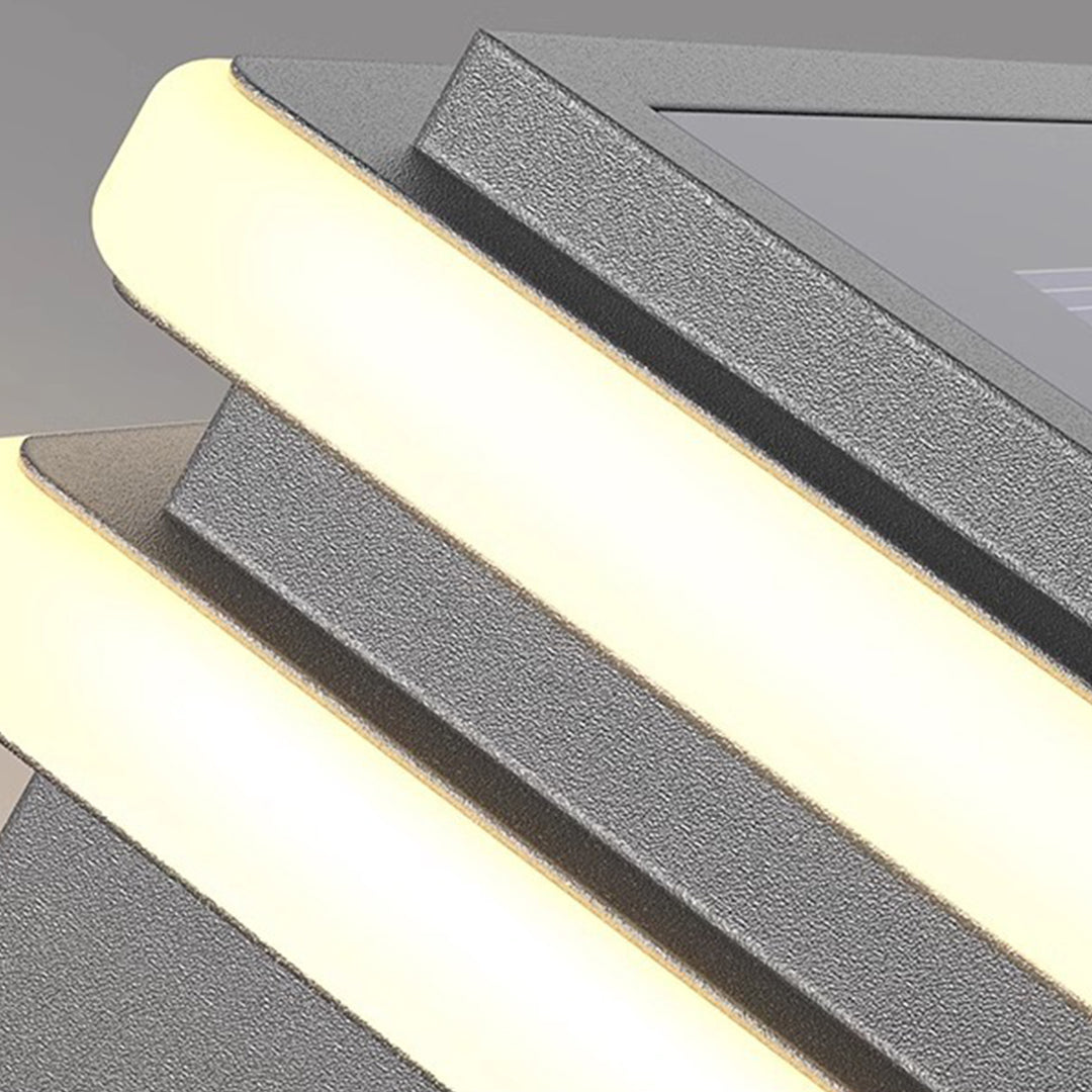 Contemporary metal pillar lights featuring horizontal LED bands on white concrete posts for modern exterior lighting