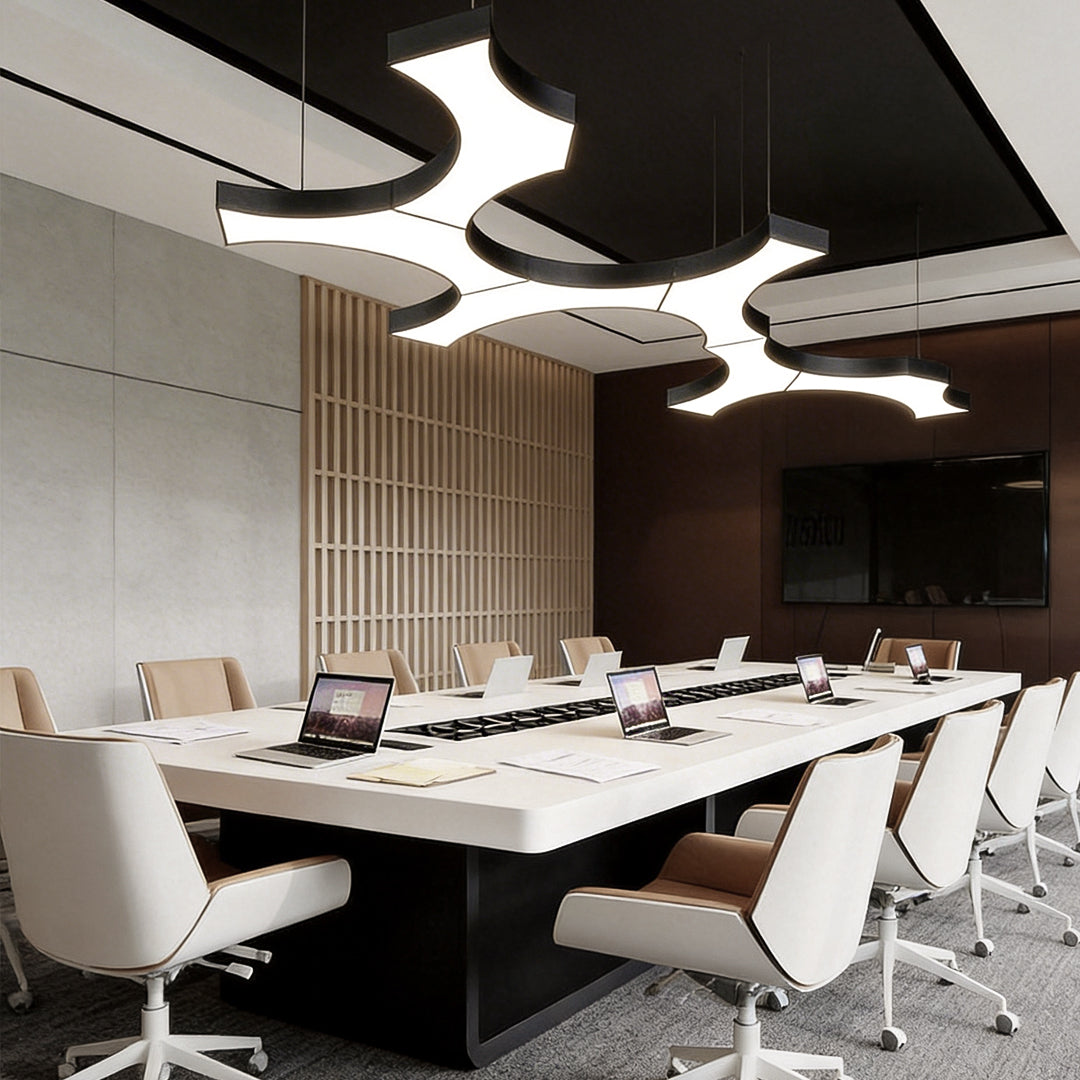 Elegant LED modern chandelier in a conference room with curved light panels and contemporary decor.