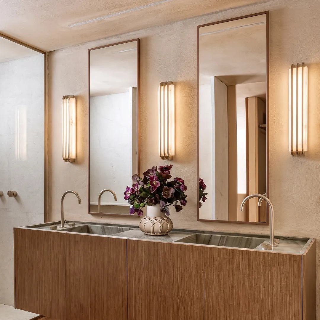 LED modern wall lights mounted beside mirrors above a double bathroom vanity.