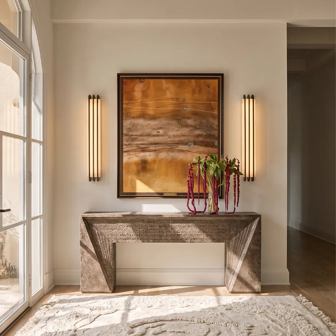 LED modern wall lights flanking a hallway console table in a warm contemporary interior.