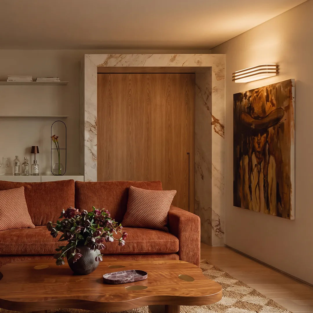 LED modern wall lights installed above a sofa in a cozy contemporary living room.