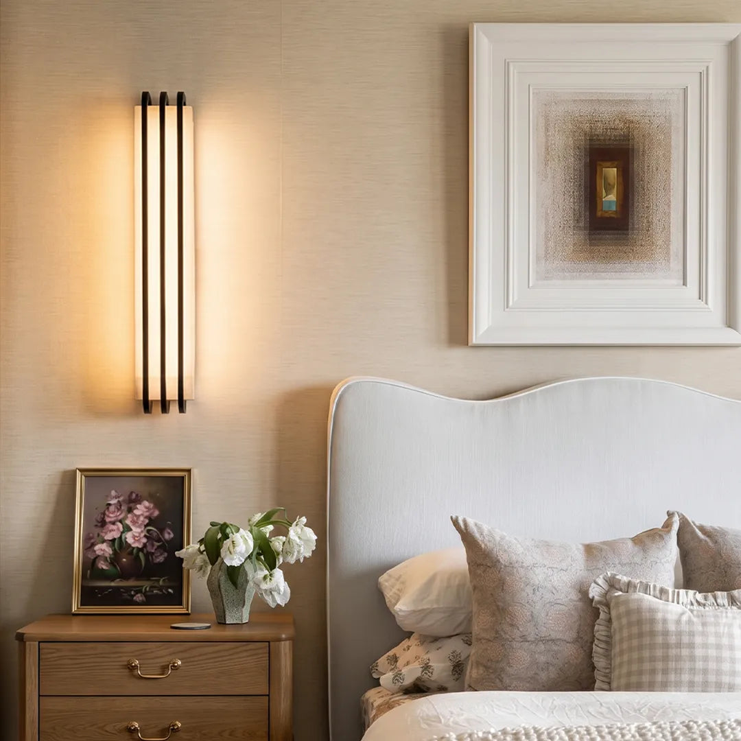 LED modern wall lights installed beside a bed in a soft neutral bedroom setting.