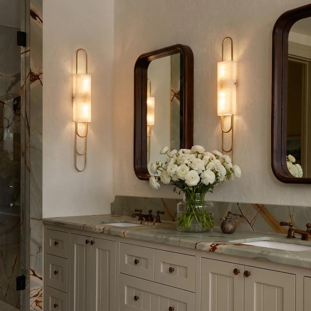 LED modern wall sconces mounted beside bathroom mirrors with a sleek vertical design and warm glow.