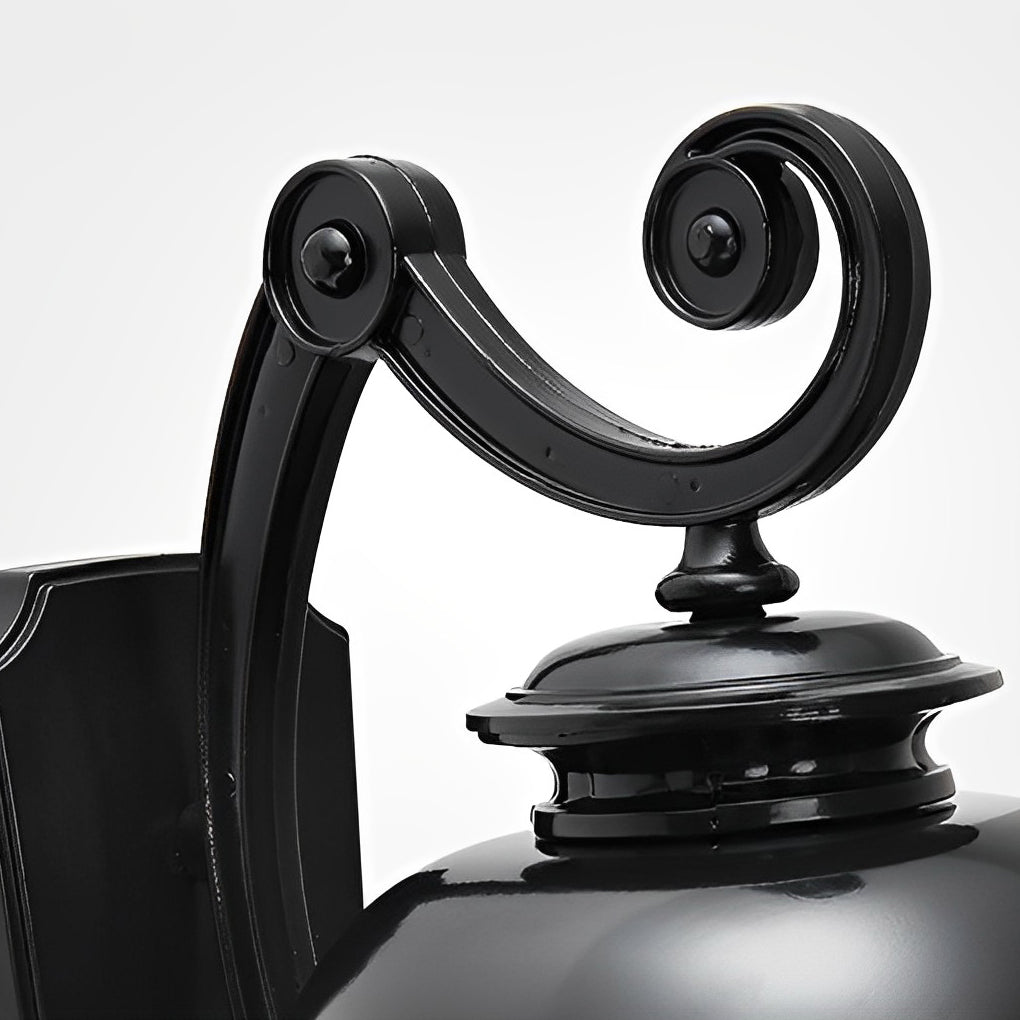 Close-up of LED outdoor sconce curved arm and mounting structure.