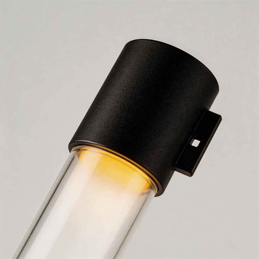 Close-up of LED outdoor sconce showcasing its cylindrical design and warm light.