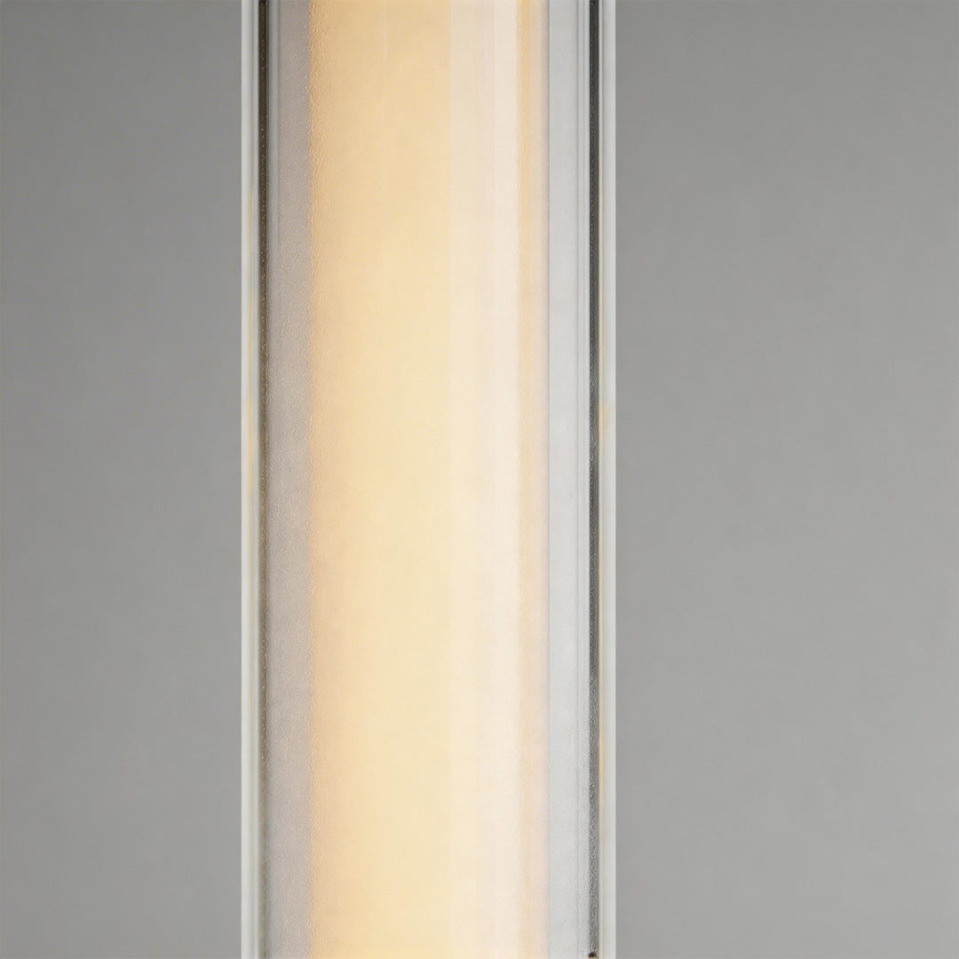 LED outdoor sconce with a sleek design, mounted on a white wall.