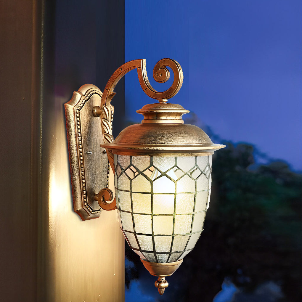 Vintage-style LED outdoor sconce featuring decorative scroll arm and warm glow.