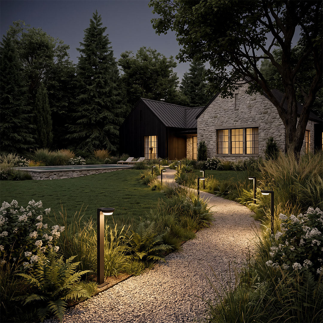 LED path lighting illuminating a winding garden walkway, featuring sleek modern pathway lights leading toward a contemporary house at dusk.