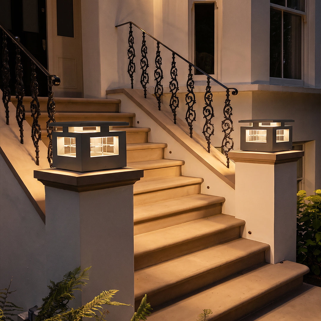 LED pillar lights installed on staircase posts, providing warm ambient lighting for a modern outdoor stairway.