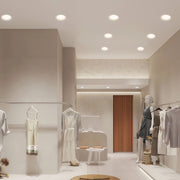 LED recessed downlights illuminating luxury retail boutique with cream walls and glass display cases