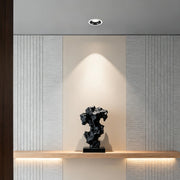 LED recessed spotlight illuminating elegant display niche with sculpture and wood paneling backdrop