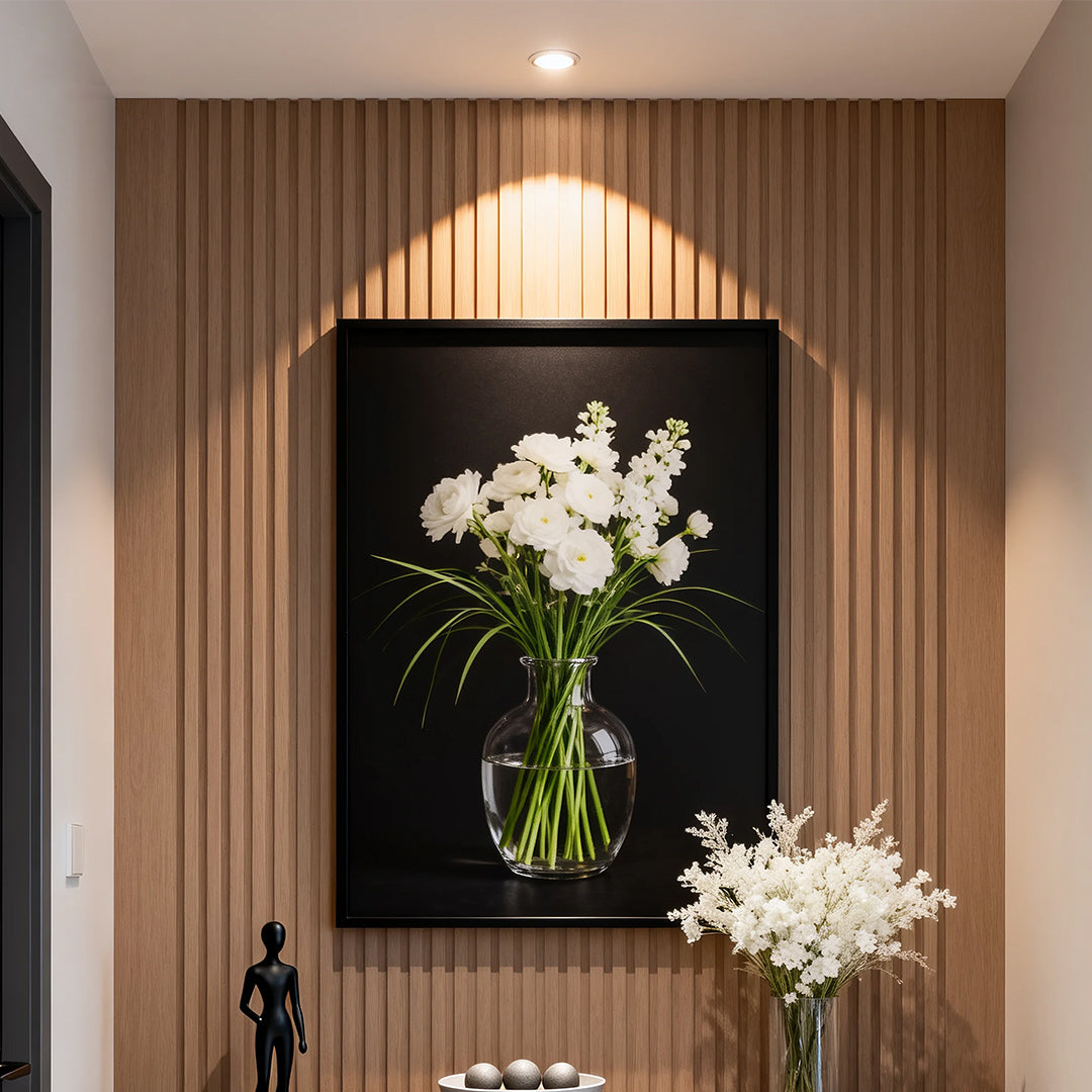 LED recessed spotlight creating warm ambiance in contemporary entryway with fluted wood wall and flowers