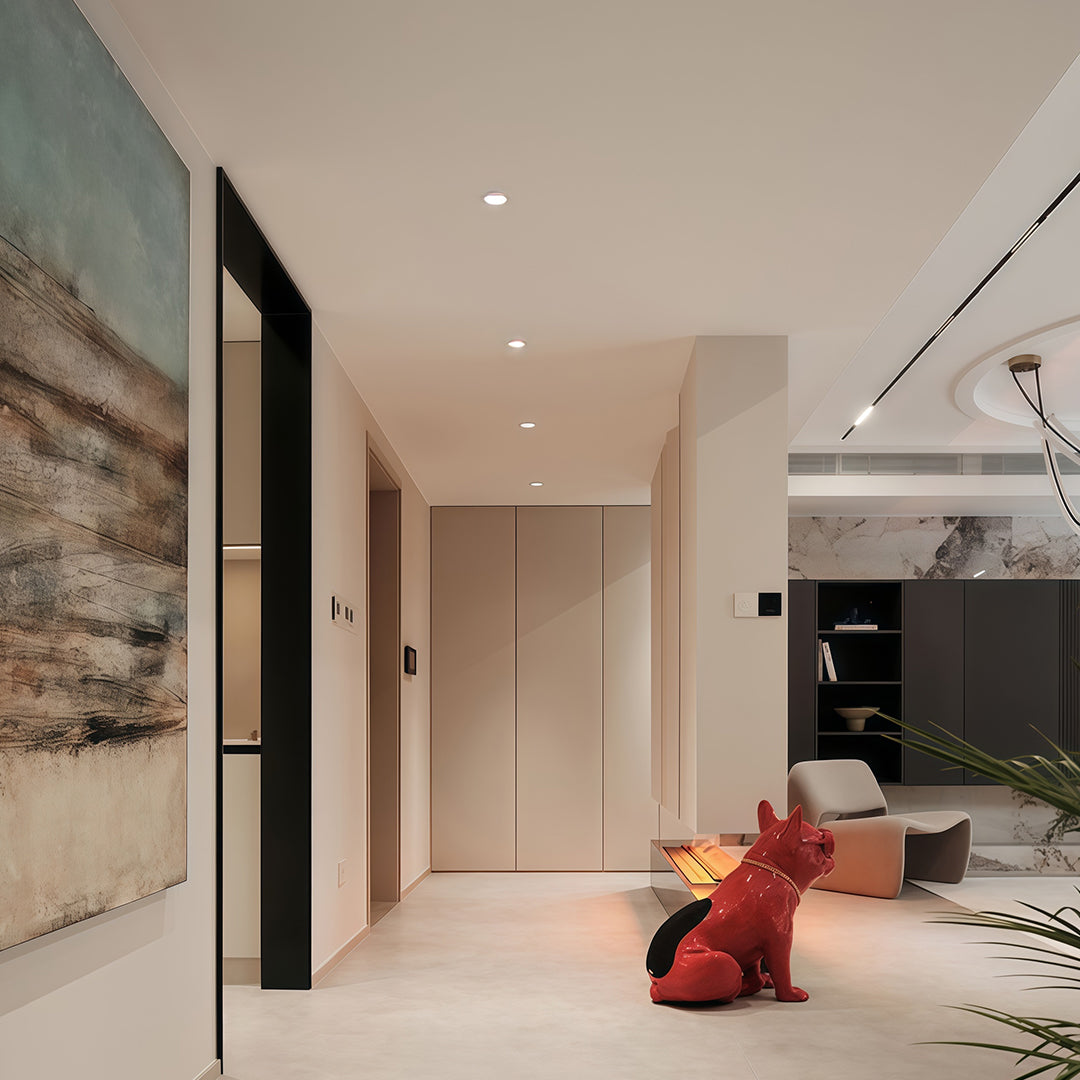 LED recessed spotlights and track lighting enhancing open-plan living space with marble accents
