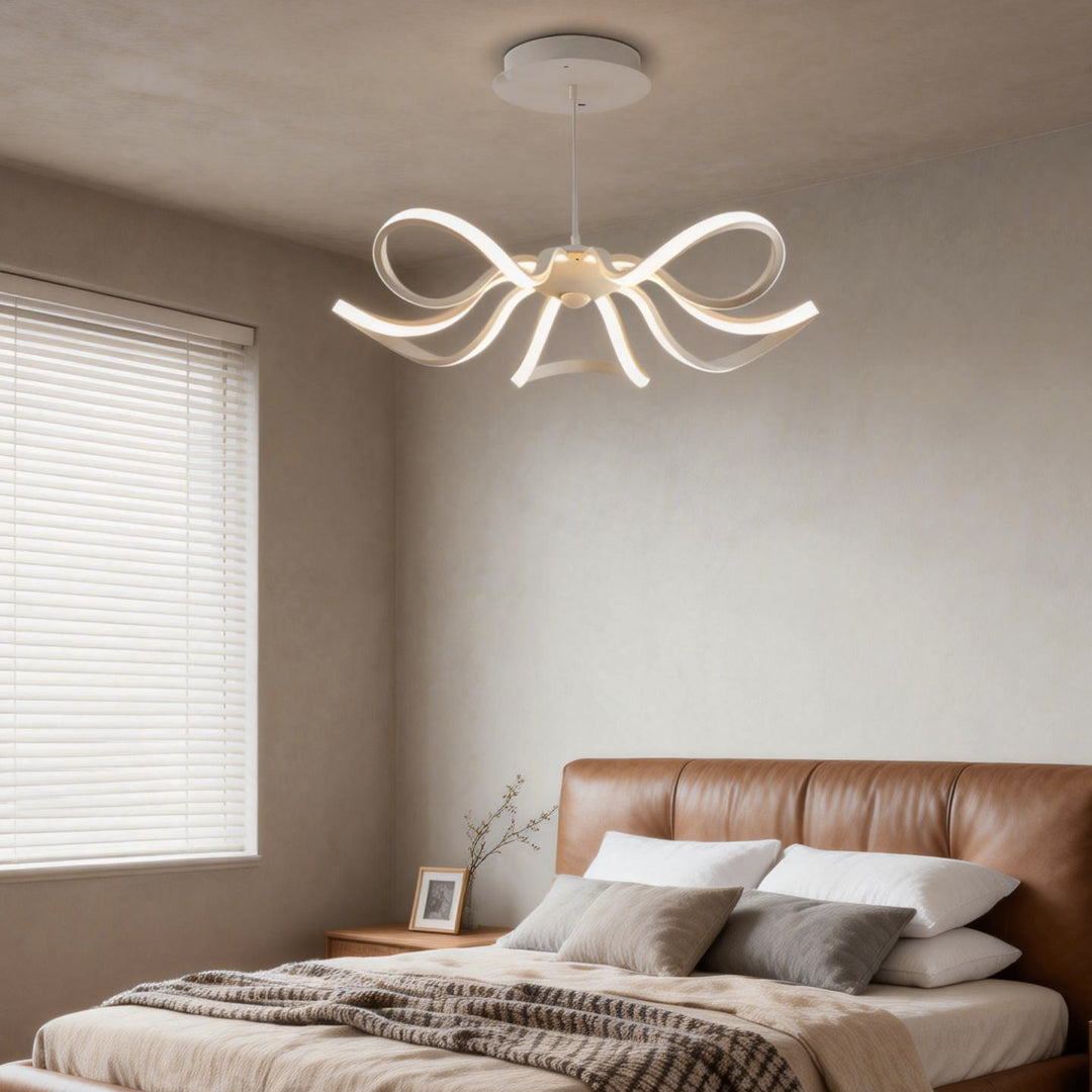 LED ribbon chandelier with a gold finish, adding a touch of elegance to a modern dining space.