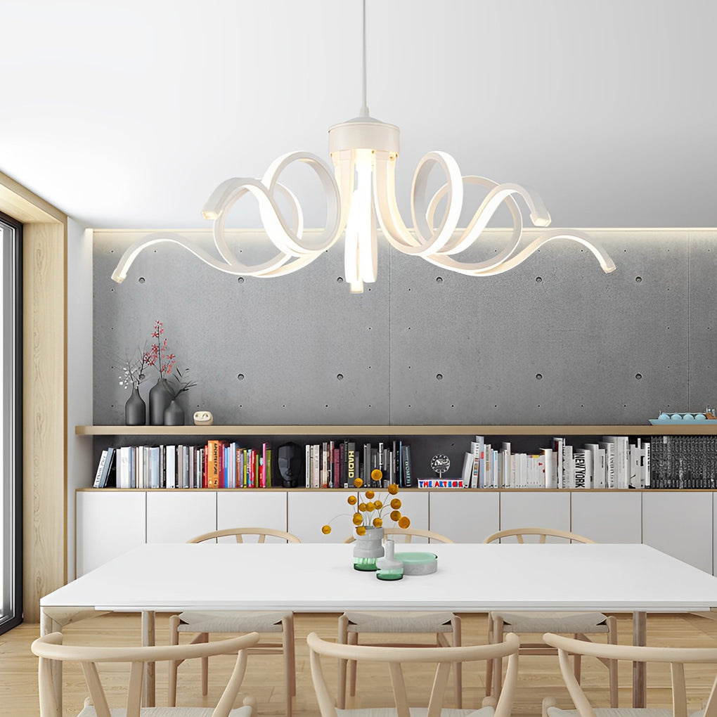 LED ribbon chandelier hanging above a white dining table, creating a focal point in a minimalist room.