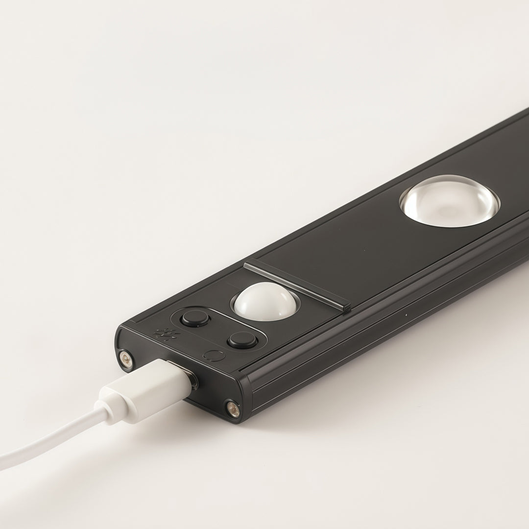 LED sensor light strip close-up showing slim black motion sensor light bar with cable connection.